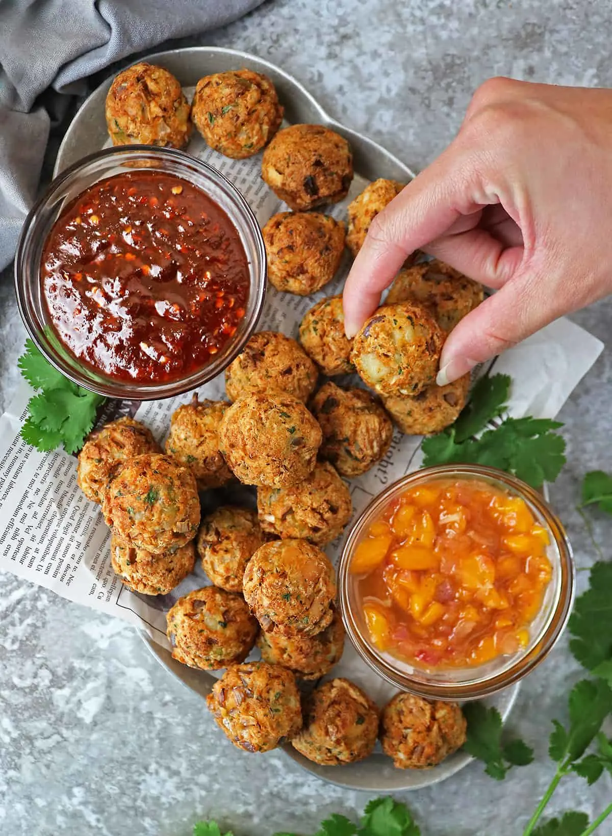 Platter of air fried salmon croquettes with mango chutney and sweet chili sauce.