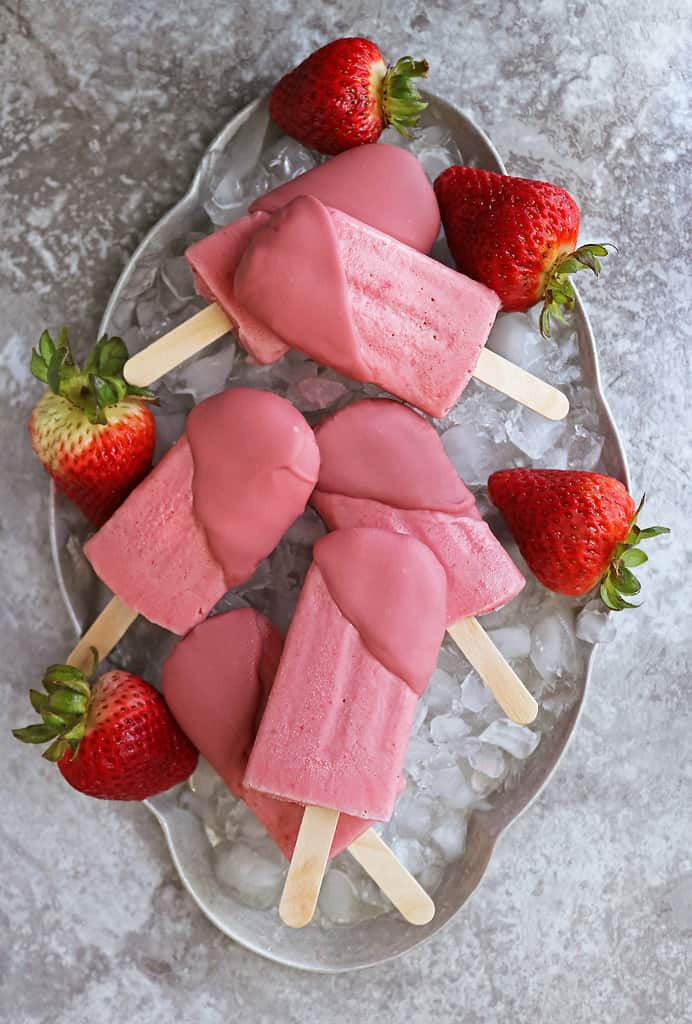 Vegan strawberry popsicles dipped in ruby chocolate