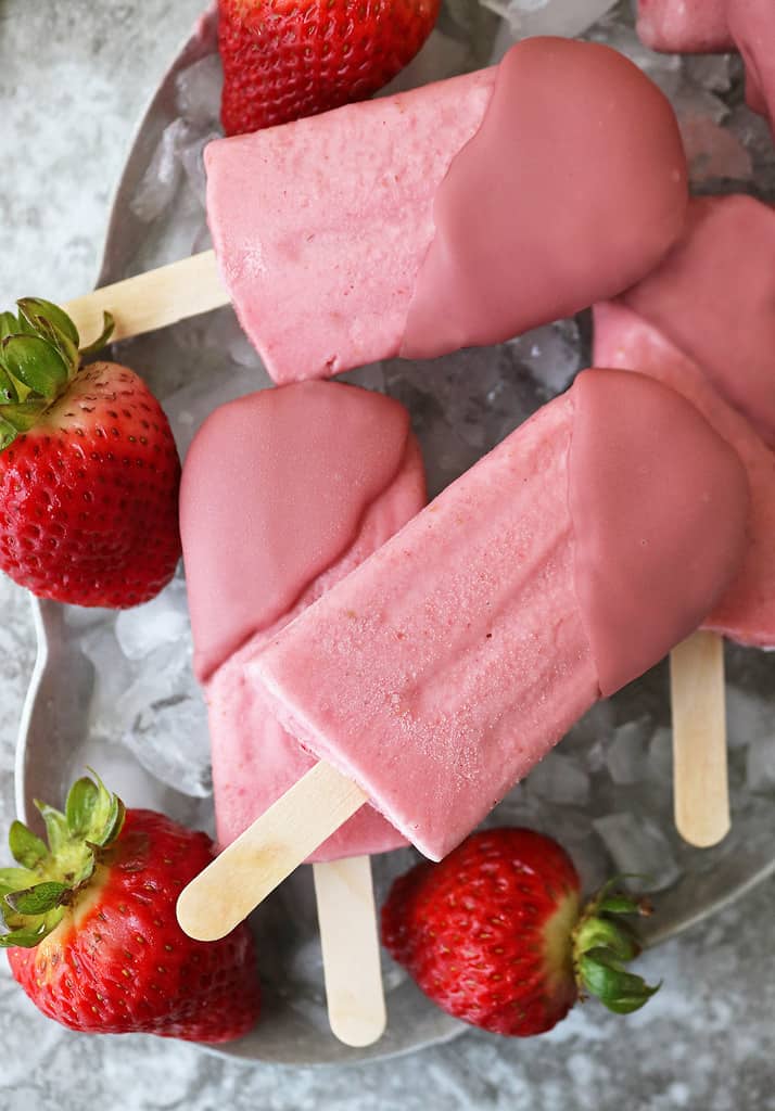 Delicious and easy dairy free strawberry popsicles dipped in ruby chocolate