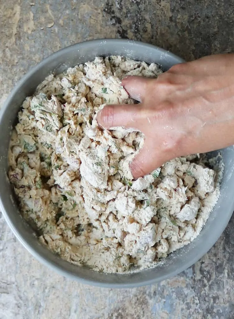 mixing pol roti dough with hands