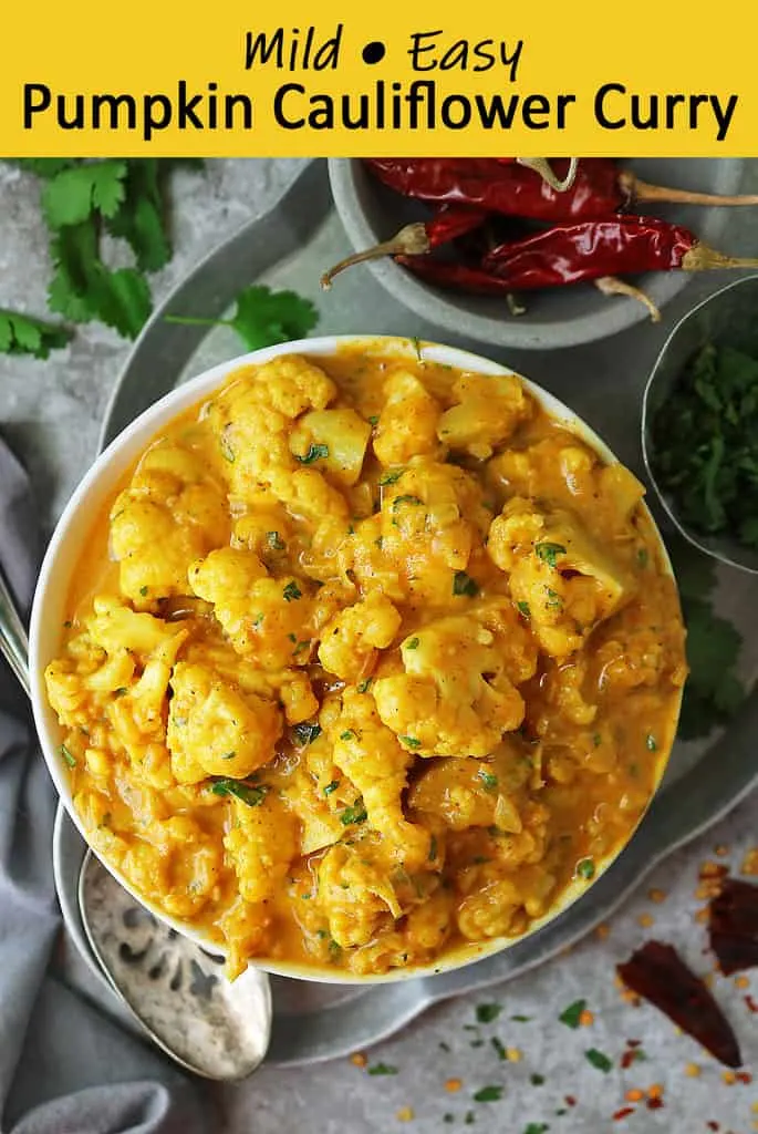 Bowl of Pumpkin Cauliflower Curry with cilantro and chili add ins.