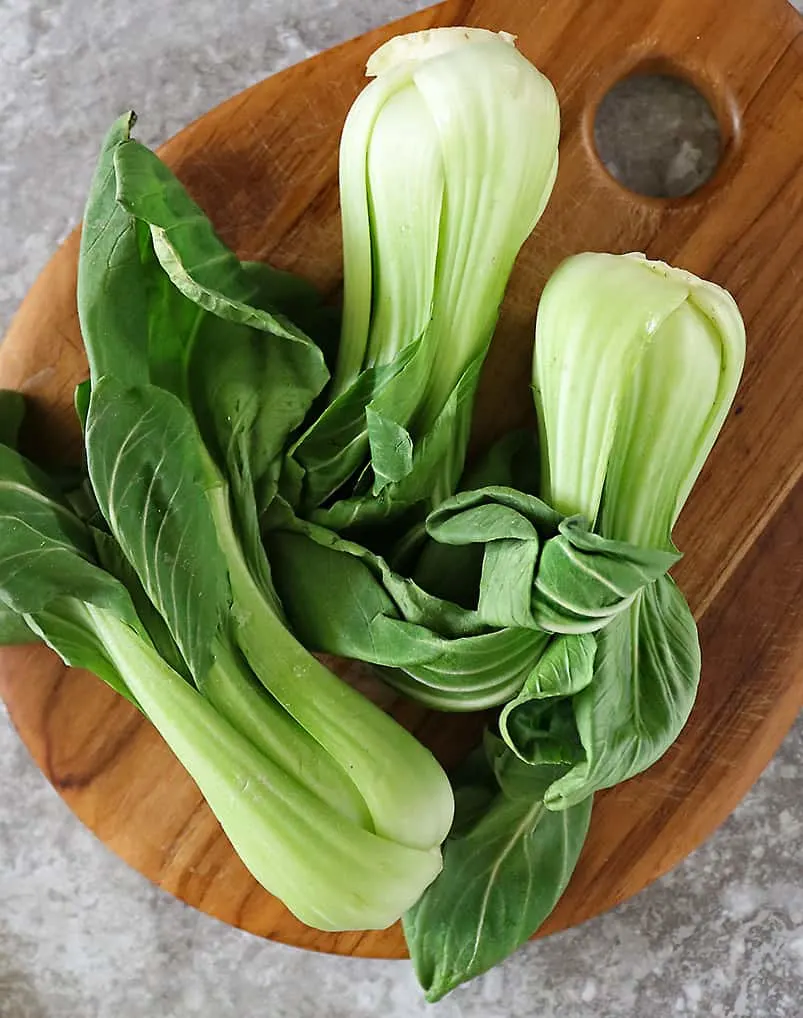 baby bok choy on a cutting board.