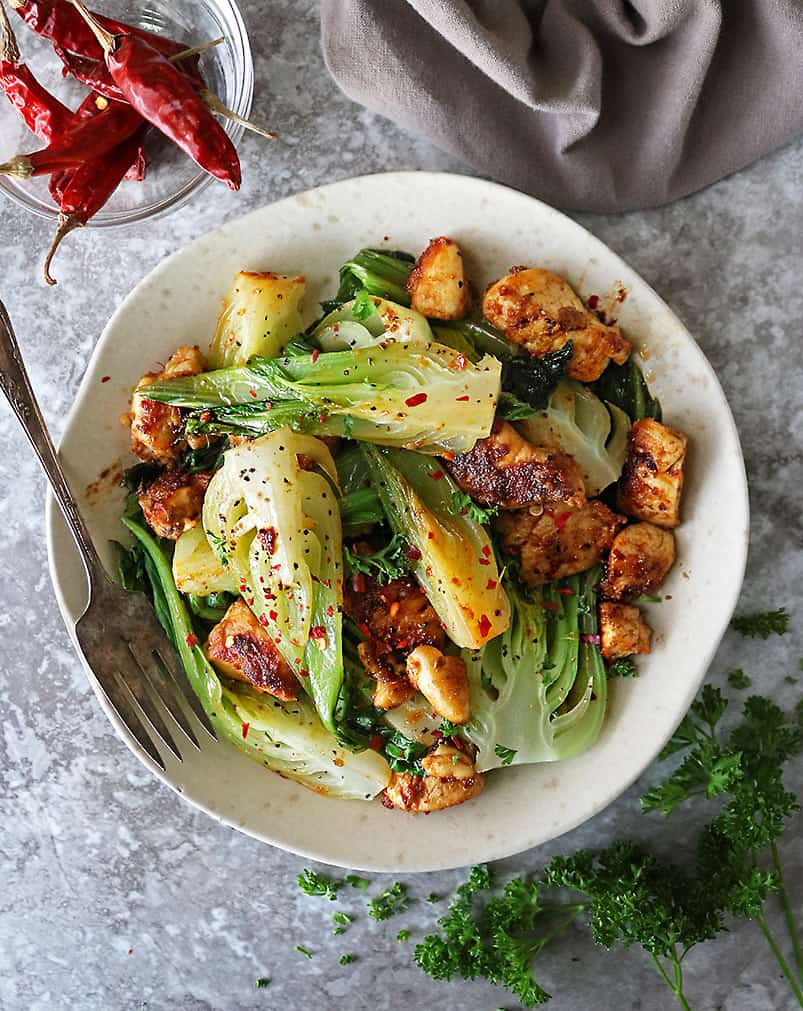 plate with easy ginger garlic chicken and baby bok choy dinner recipe.