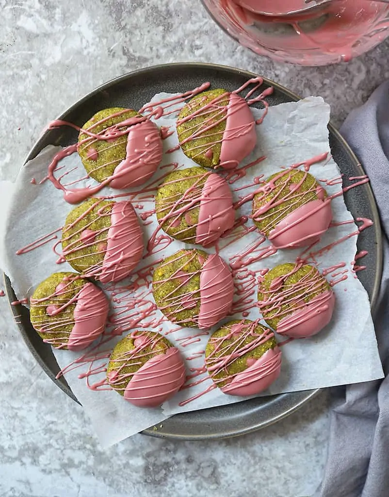 No-bake pistachio cookies with ruby chocolate drizzled with ruby chocolate.