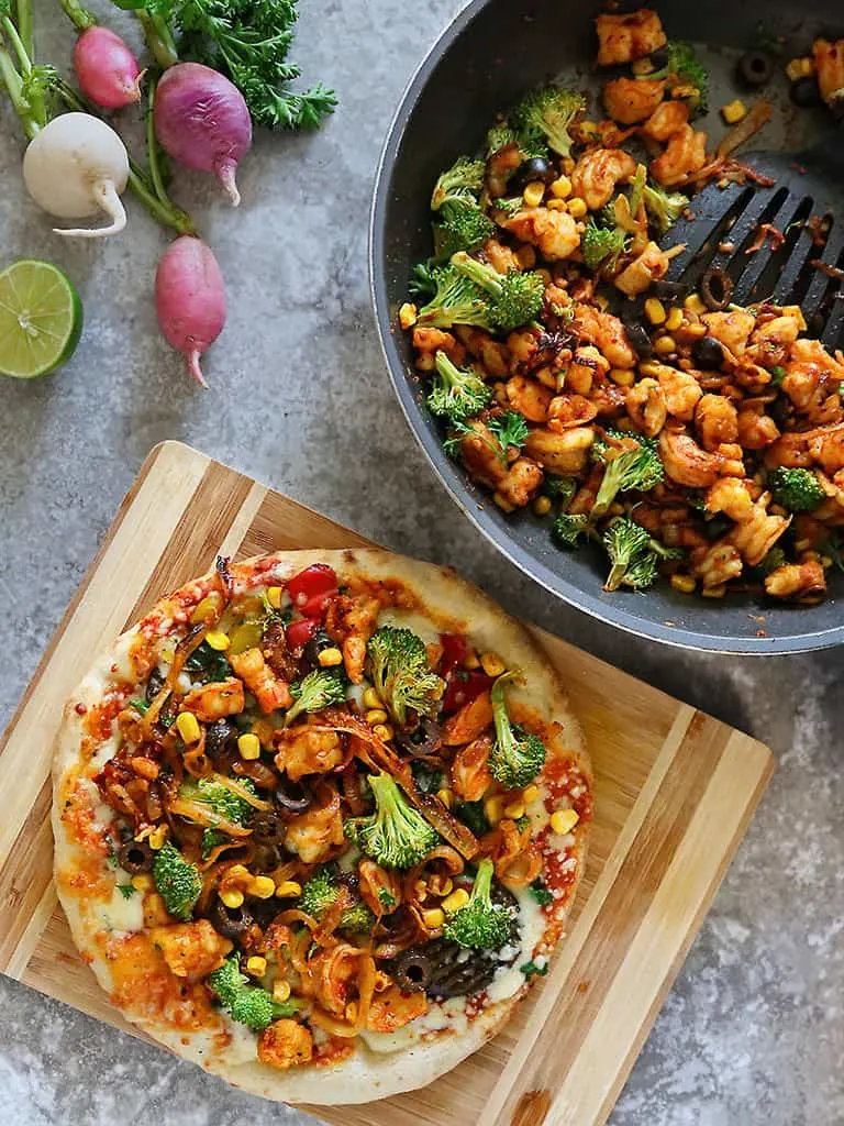 Shrimp Broccoli loaded Pizza along with a pan of spicy shrimp broccoli saute.