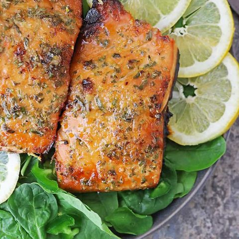 A plate with 2 fillets of honey lemon salmon - air fried to perfection.