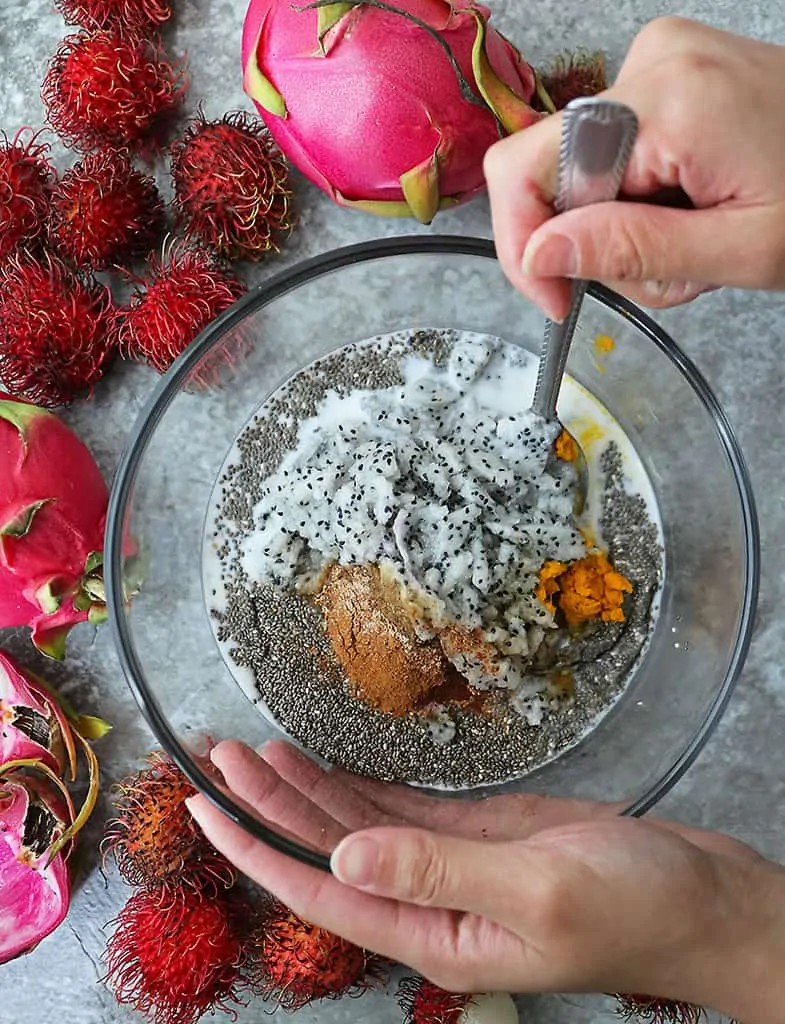 Mixing all the ingredients together to make dragon fruit chia breakfast pudding