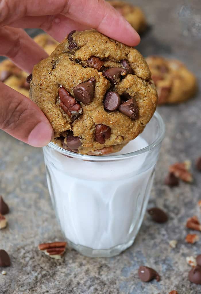 dipping one of these eggfree soft pumpkin chocolate chip cookies into a glass of milk.