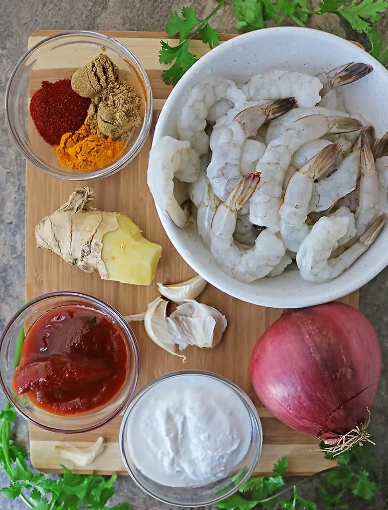 Ingredients to make shrimp curry on board on a flatlay