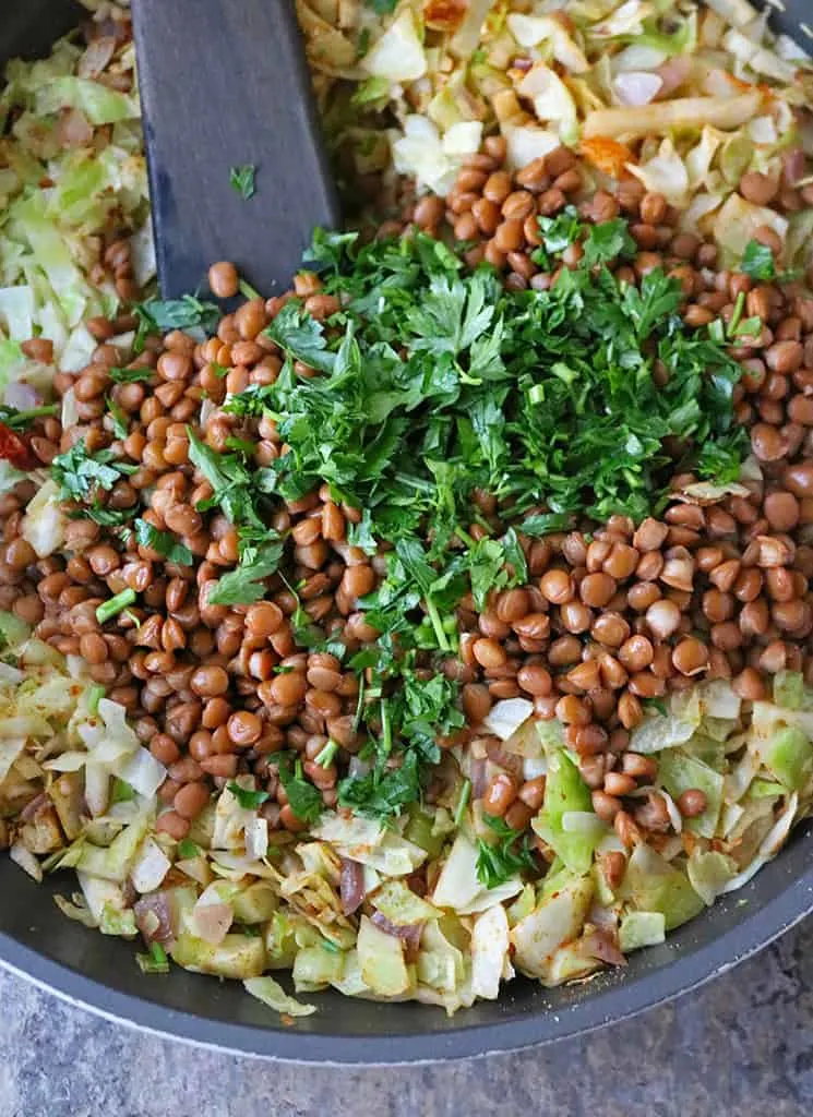 sauteing ingredients to make cabbage salad with lentils