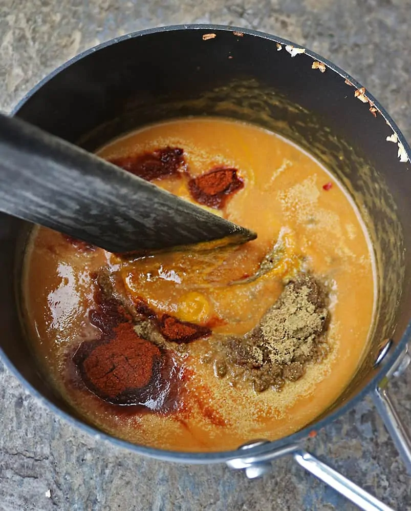 Mixing the ingredients together for pumpkin curry soup