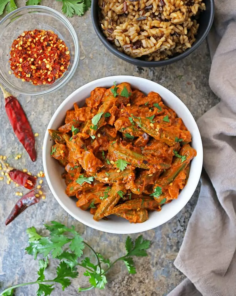 Tasty okra curry in a bowl with rice in another bwl