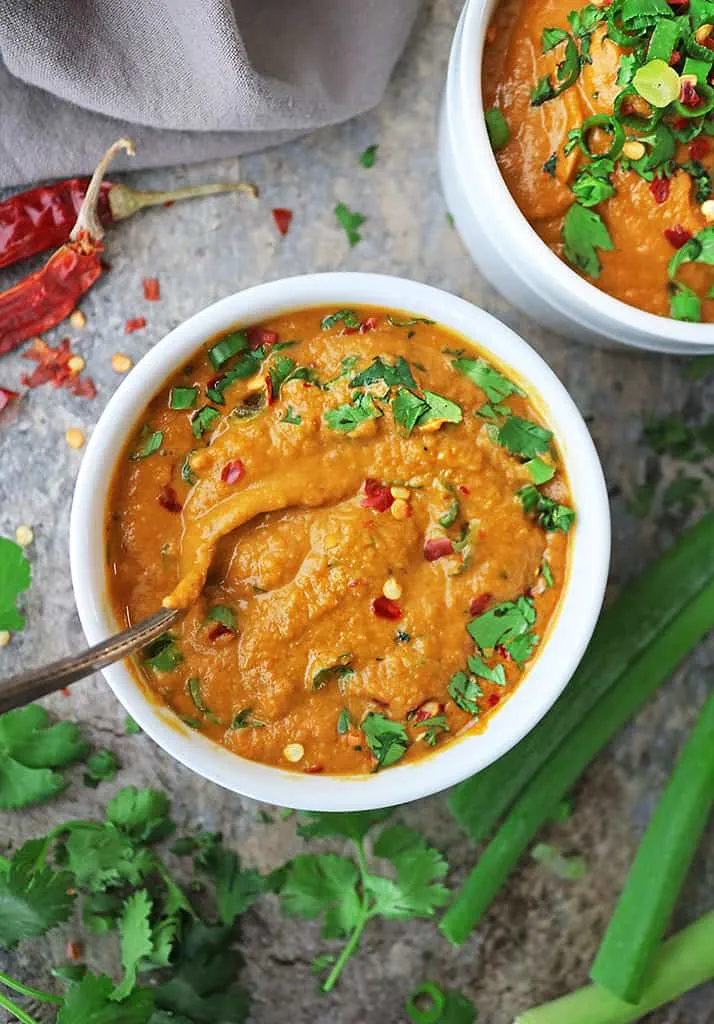 enjoying a bowl of healthy pumpkin curry soup