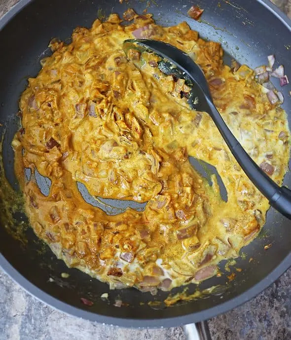 mixing spices to make shrimp curry