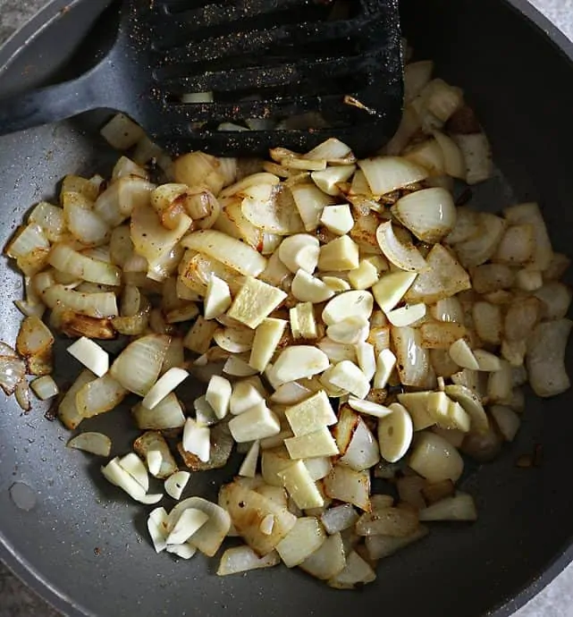 sauteing onions ginger garlic to make spinach curry sauce