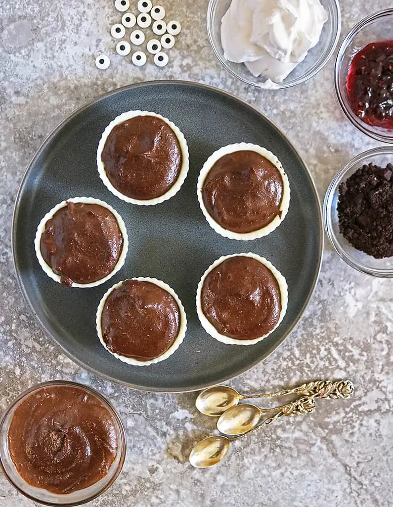  Plate of chocolate cashew pudding filling in white chocolate cups