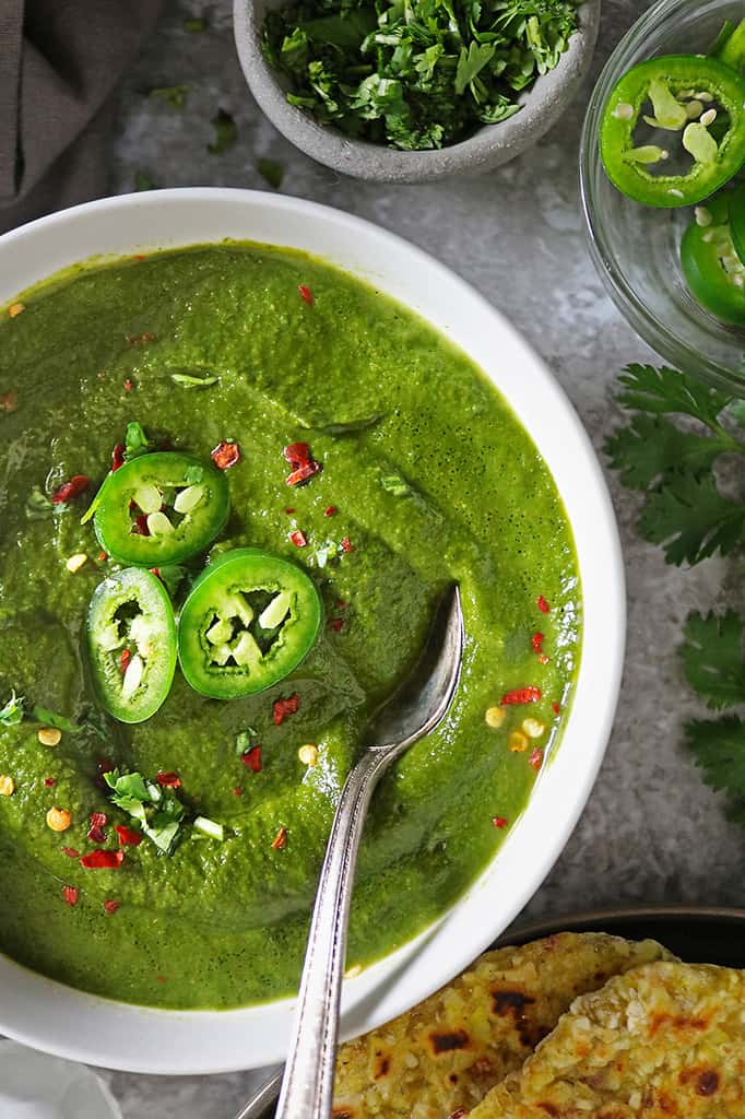 Spoonful of spinach curry soup with coconut milk