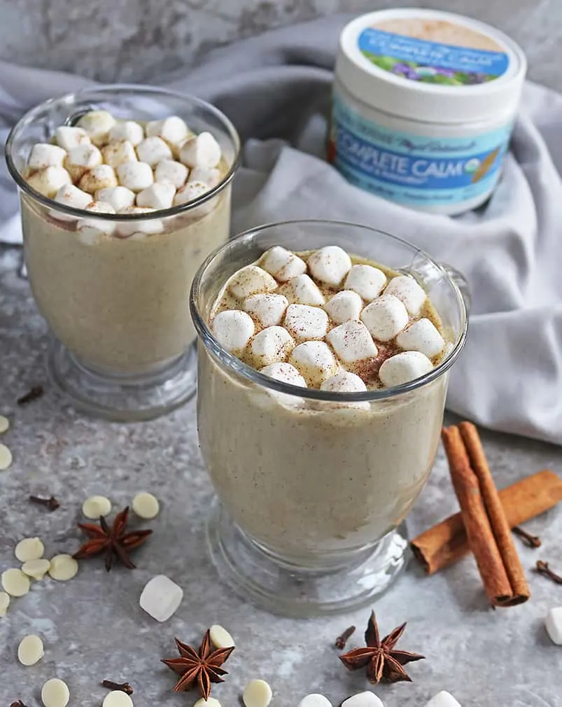 Two mugs of Delicious Spiced White chocolate with completely calm powder in the background