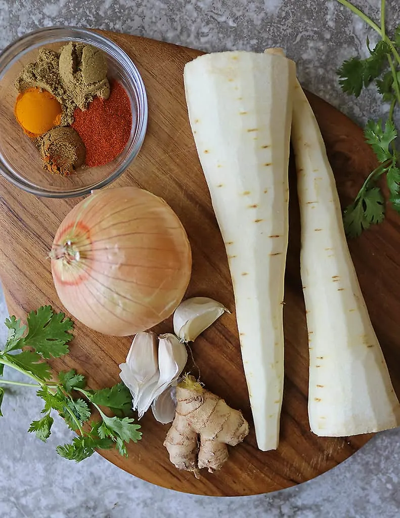 A flatlay of the ingredients to make Golden Pan Roasted Parsnips