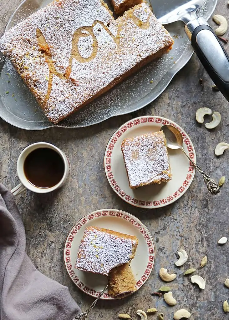 Small-batch eggless Sri Lankan Love Cake Recipe on two plates and a serving platter with a cup of coffee.