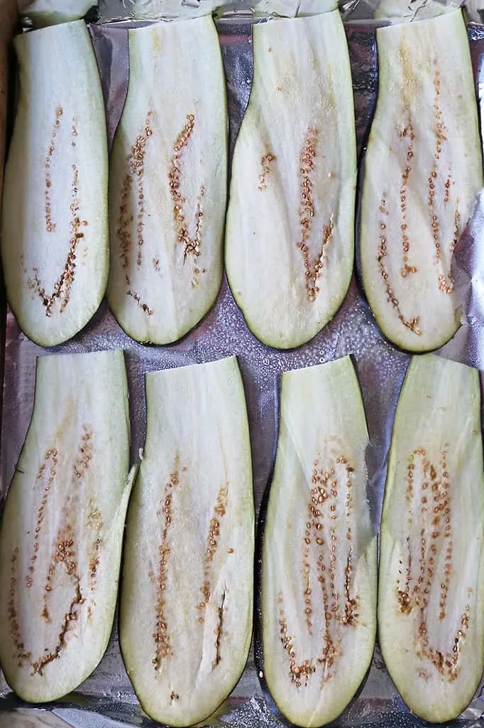 Brushing eggplant slices with oil and baking them