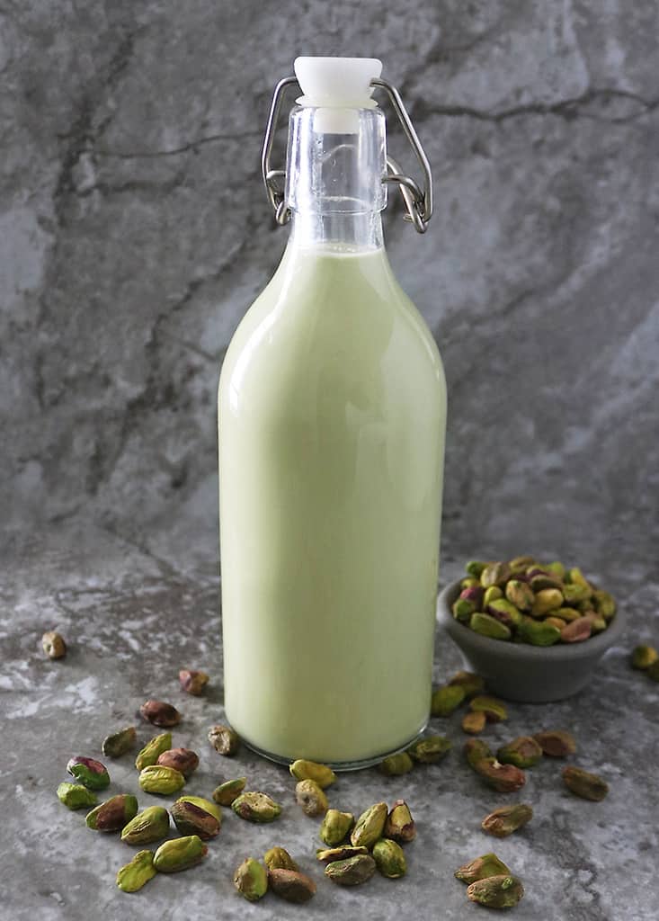 A large glass bottle filled with Easy plant-based Pistachio milk