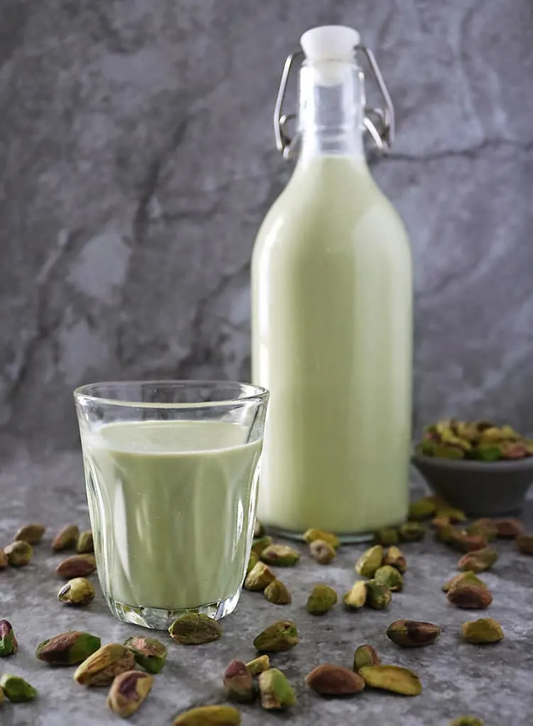 A bottle and a glass cup of Easy plant-based - clean keto Pistachio milk