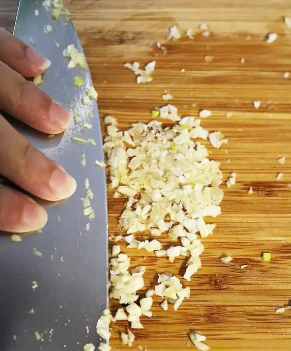 Crushing or "creaming" garlic salt for dressing