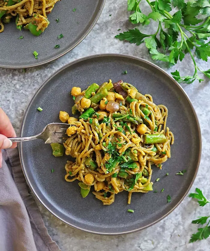 Digging into a plate of tasty curry noodles.