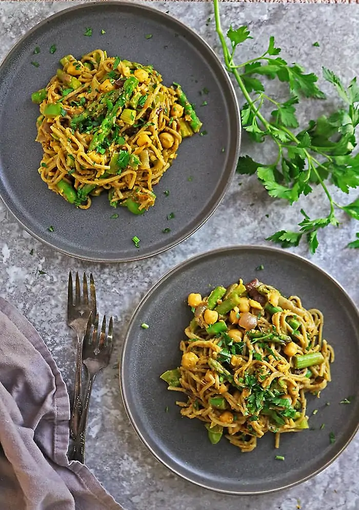 Two plates of tasty plant based curry noodles for dinner