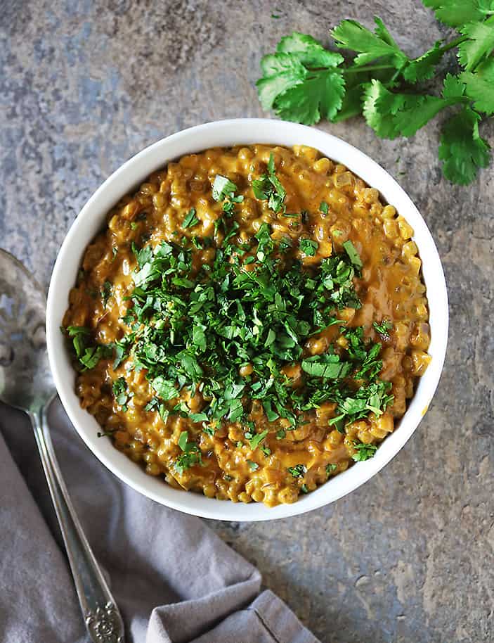 Moong beans are cooked in a spiced coconut milk sauce for a tasty plant based curry