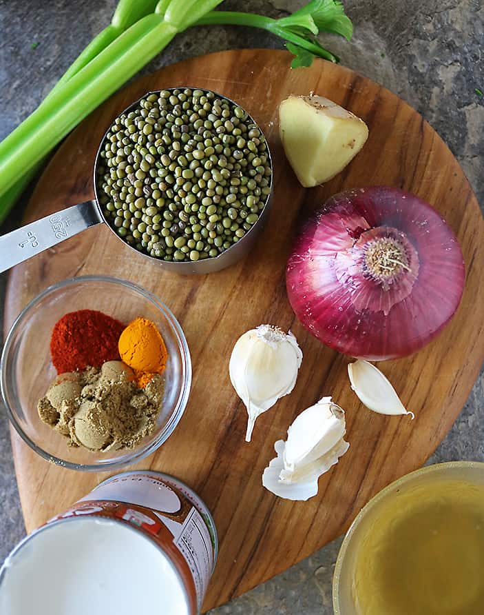 the ingredients to make a tasty thick creamy plant protein rich curry laid on a wood board.