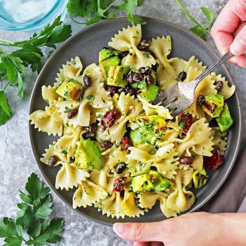This Grilled Avocado Sundried Tomato Pasta Salad is an easy and quick meal that is incredibly flavorful thanks to grilled avocado and a lemon garlic herb dressing.