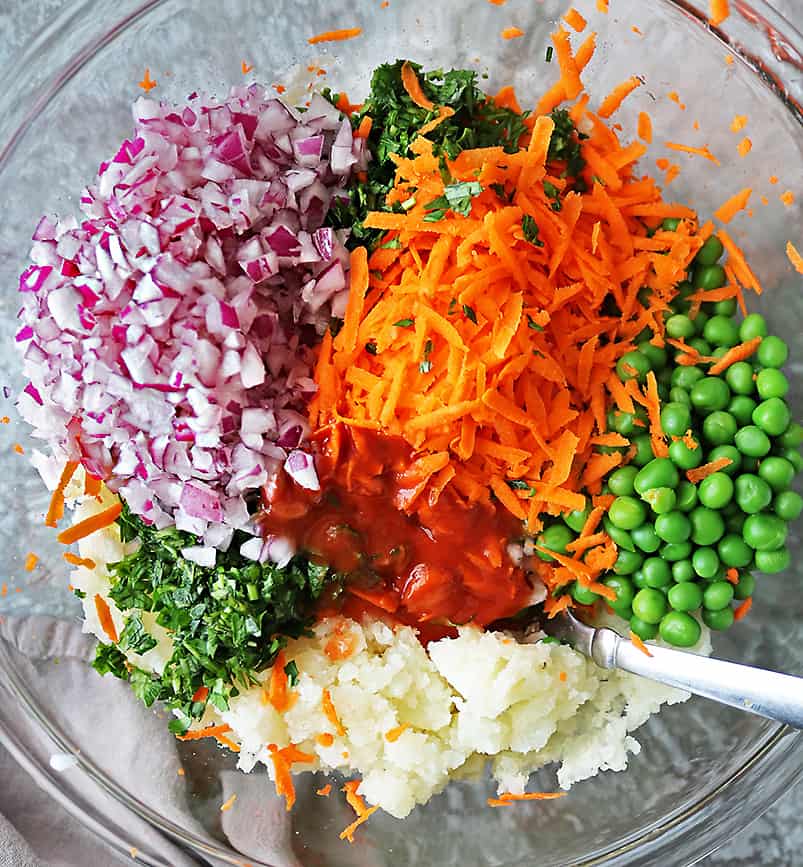 Mixing together ingredients to make veggie fritters