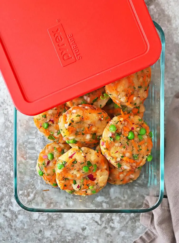 Photo with uncooked veggie fritters in Pyrex dish with cover partially on.