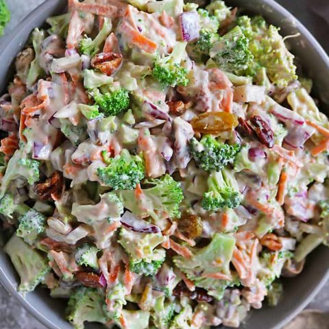 Overhead photo of Tasty vegan broccoli salad in a large grey bowl.
