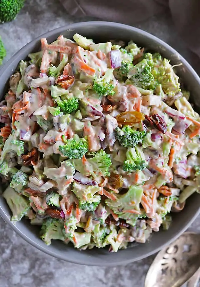 Overhead photo of Tasty vegan broccoli salad in a large grey bowl.