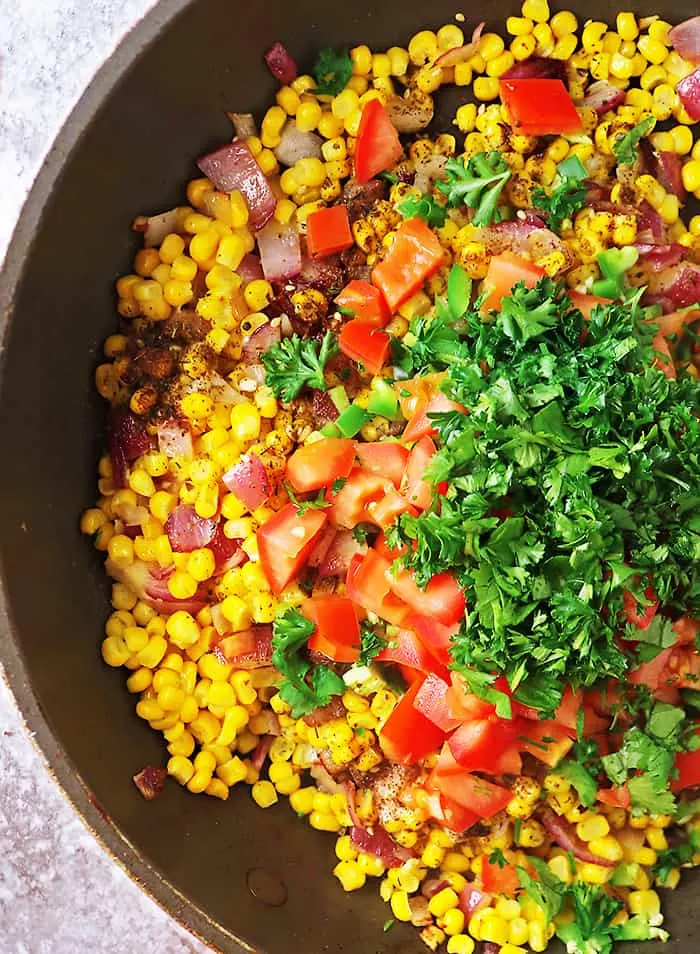 Sauteing the ingredients together for the best corn salad recipe