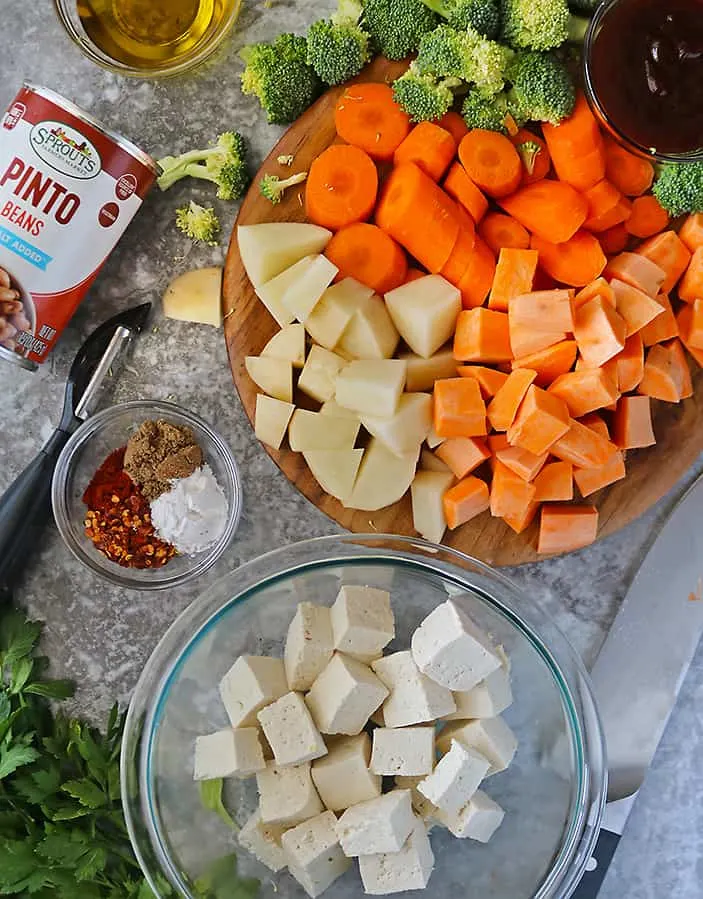 tofu and veggies cut up and ready to be seasoned before baking.