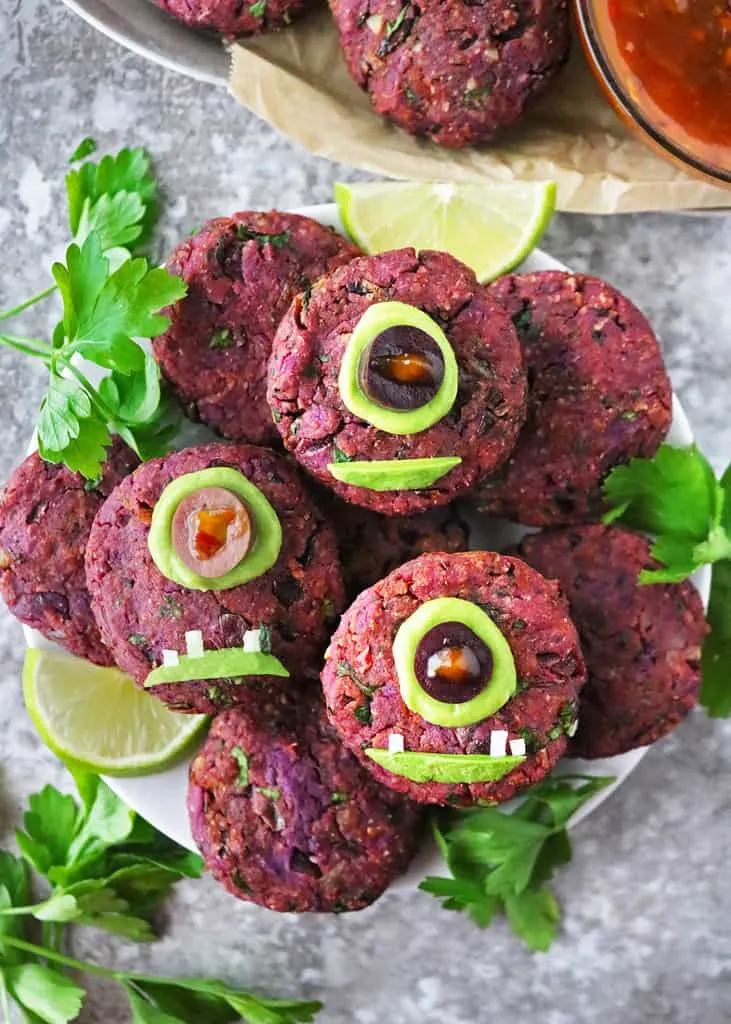 A tray with tasty and fun Vegan one eyed purple people eater fritters.