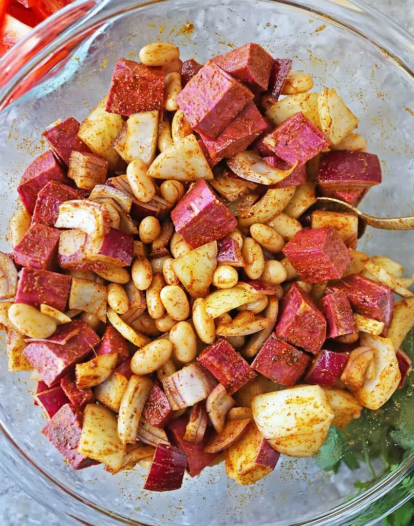 coating veggies with ras el hanout cayenne mixture