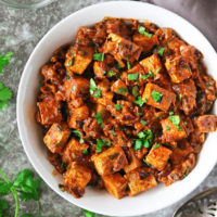 A bowl full of A Dairy-free gluten-free Harissa Tofu Curry ready to enjoy.
