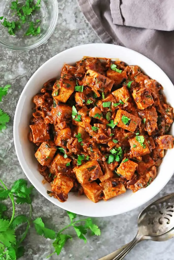 A bowl full of A Dairy-free gluten-free Harissa Tofu Curry ready to enjoy.