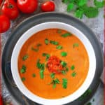 This creamy Roasted Tomato Soup Recipe is a simple one that consists of blending a sheet pan of roasted and scrumptiously spiced, tomatoes, onions, garlic, ginger, and chili peppers with a bit of almond milk. This dairy-free recipe is perfect when paired with some bread or a grilled cheese sandwich, and is ready in 35 minutes.