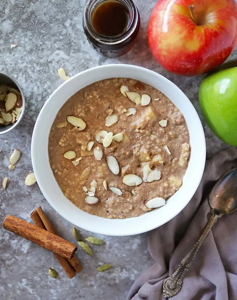 Easy breakfast couscous with cinnamon apples in a white bowl.