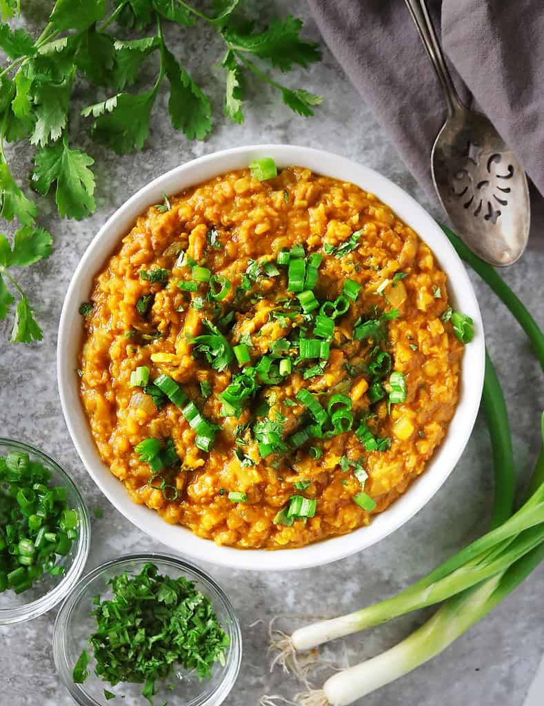 Easy tasty spicy pumpkin lentil curry made with dried lentils in a bowl.