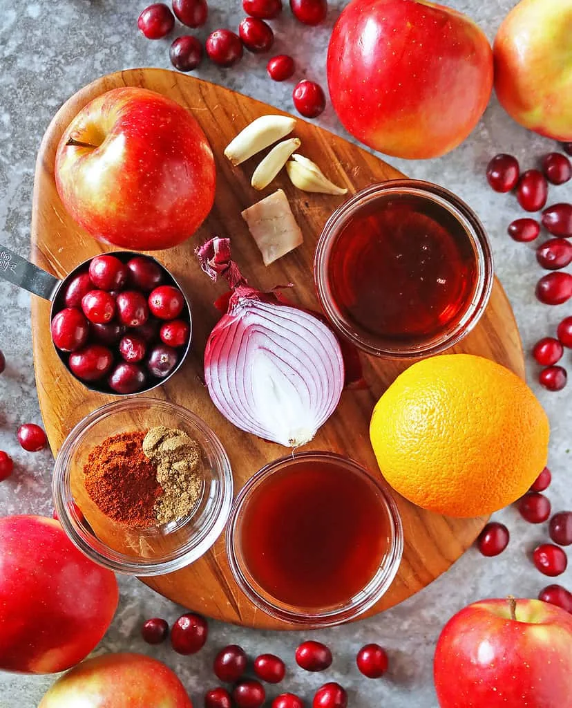 Ingredients to make the best Cranberry Apple Chutney on a wood board.