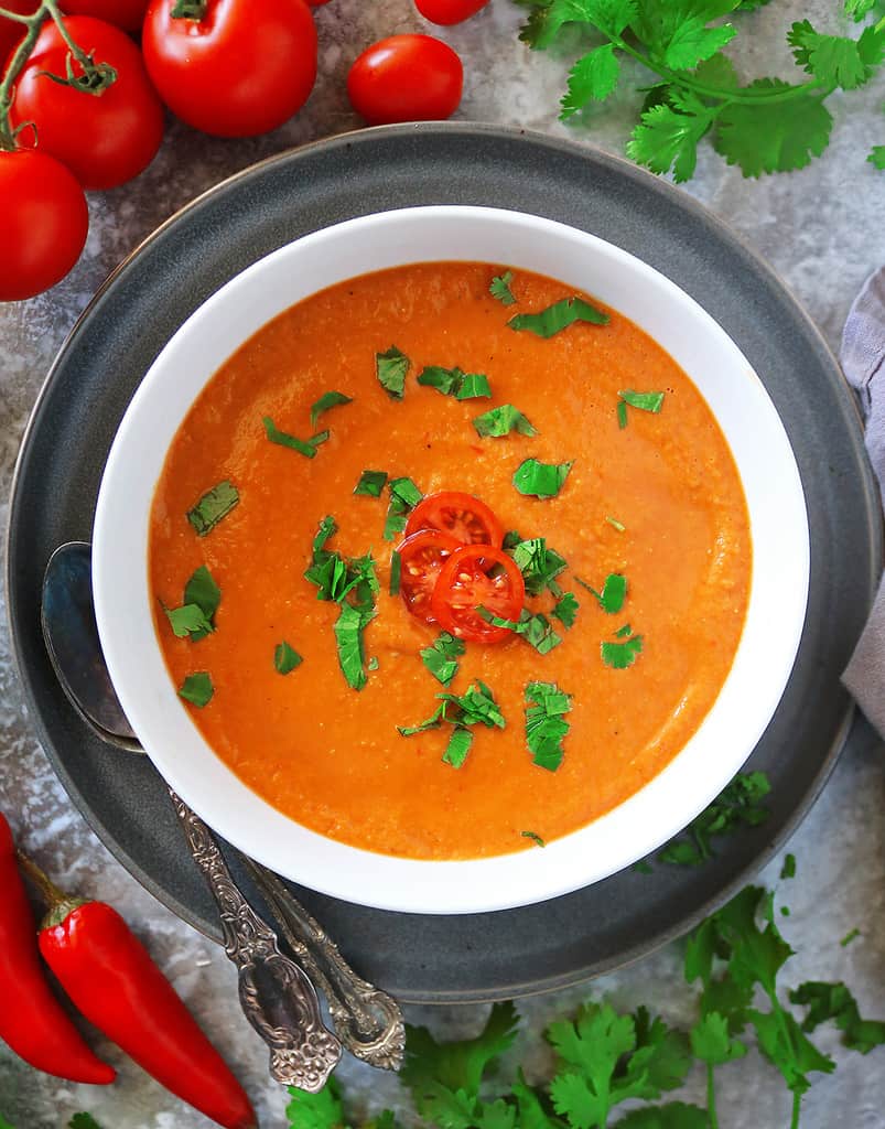 A bowl with Roasted tomato soup with garlic and ginger.