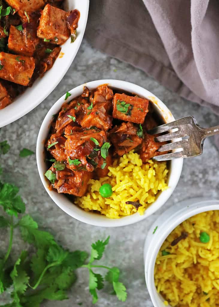 Delicious dairy-free easy harissa tofu curry is served with aromatic yellow rice.