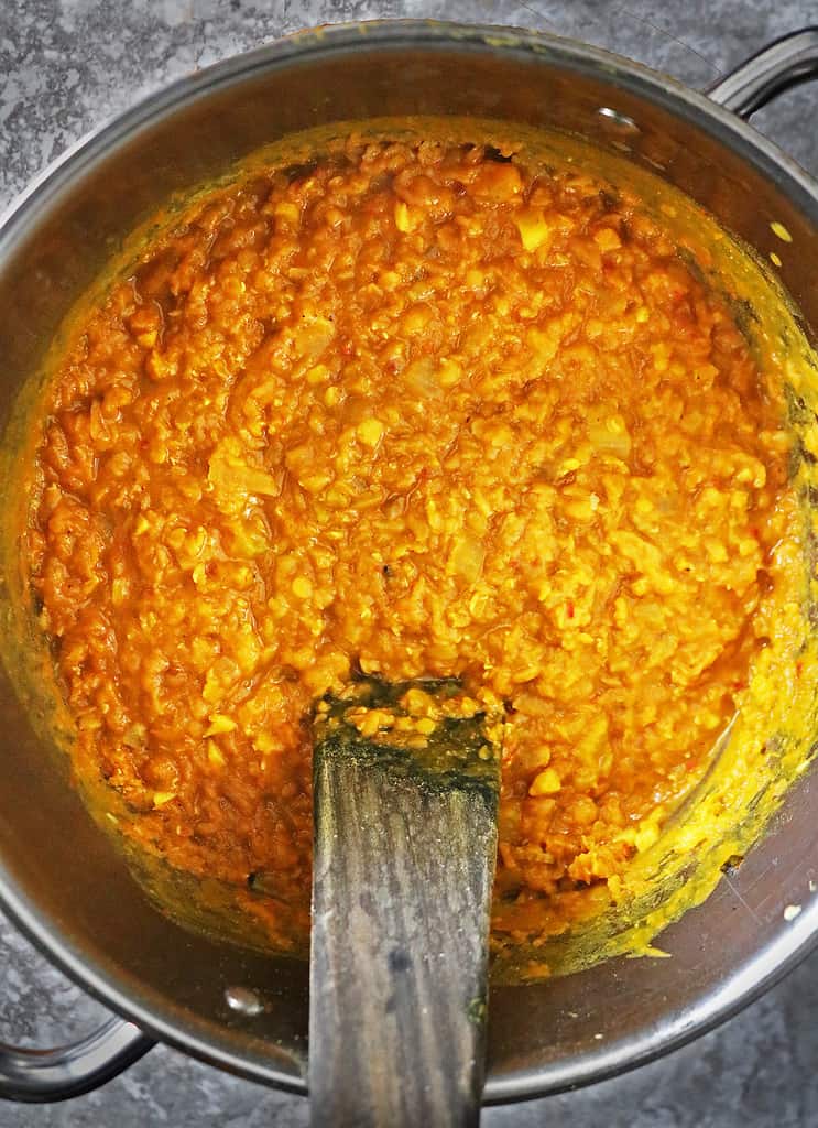 A pan with creamy hot and delicious pumpkin lentil curry just off the stove.